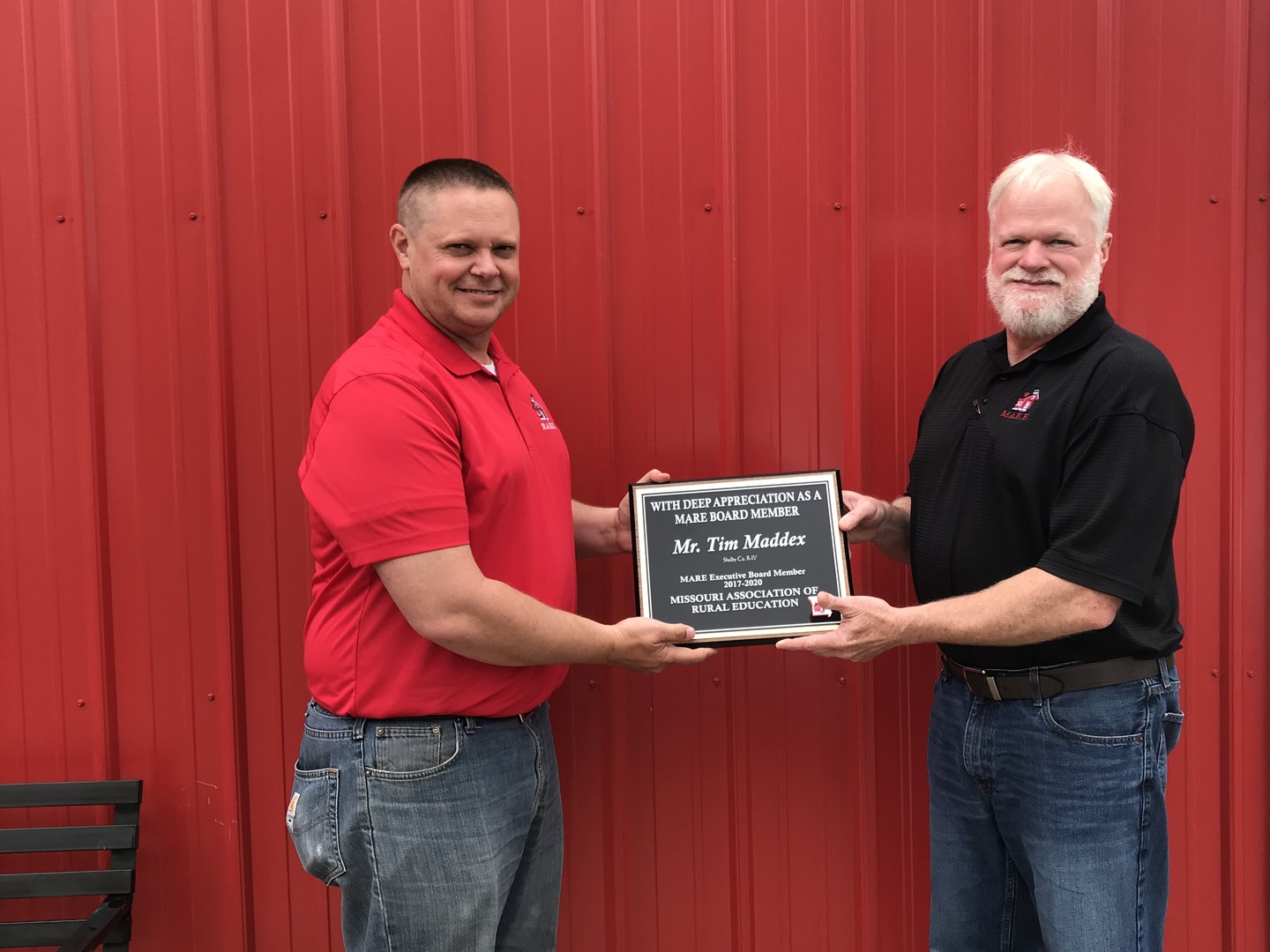 Mr. Tim Maddex receiving his service plaque from Kevin Sandlin
